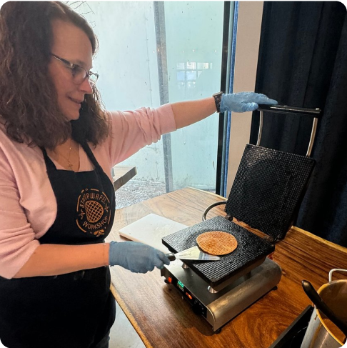 Image Description: A person making a stroopwafel.