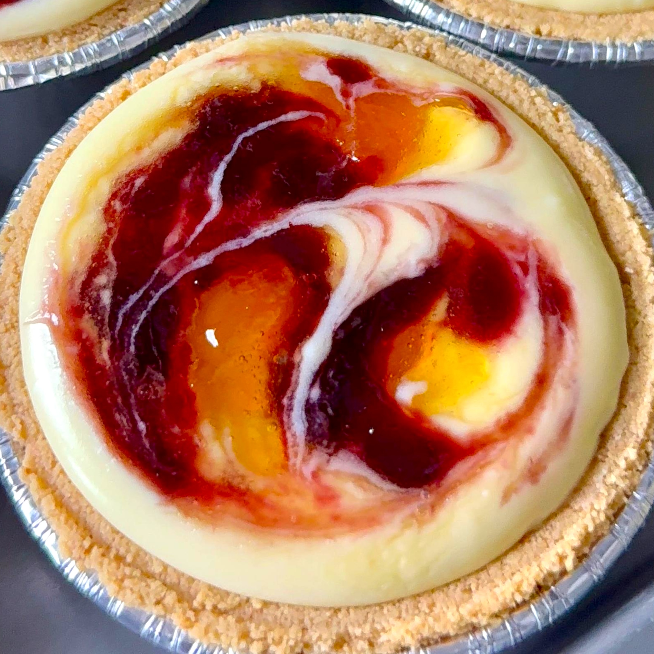 Raspberry Peach Swirl Mini Cheesecakes