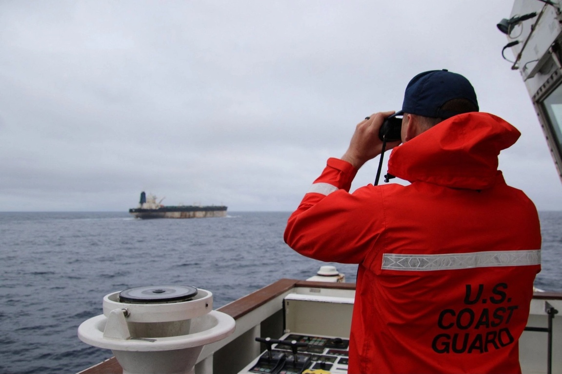 A US Coast Guard official looks through binoculars at the ship Marinera