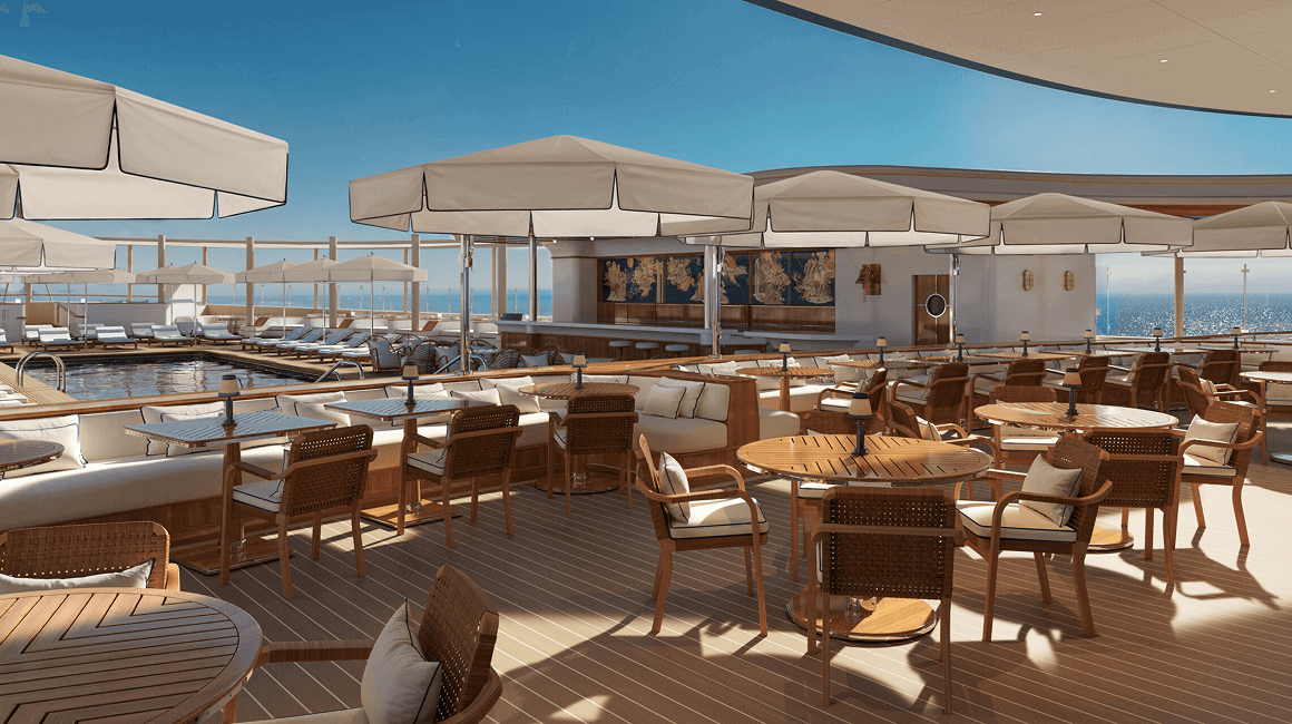 An outdoor lounge area with wooden tables and white umbrellas, with a pool visible in the background.