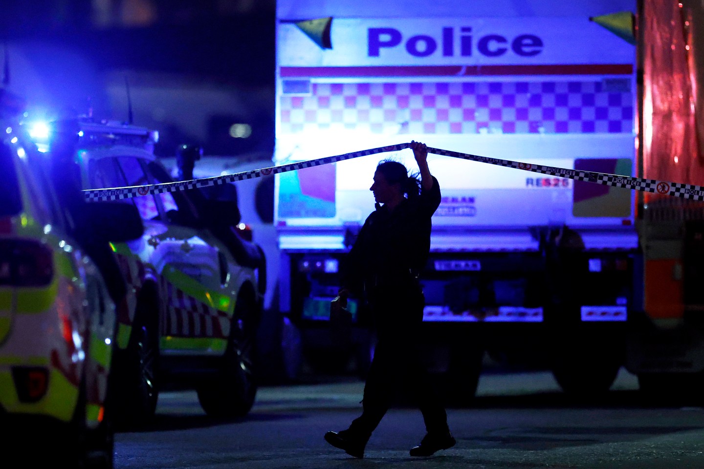 A police officer walks along cordon tapeline at the scene of a mass shooting at Bondi Beach on December 14, 2025, in Sydney, Australia.