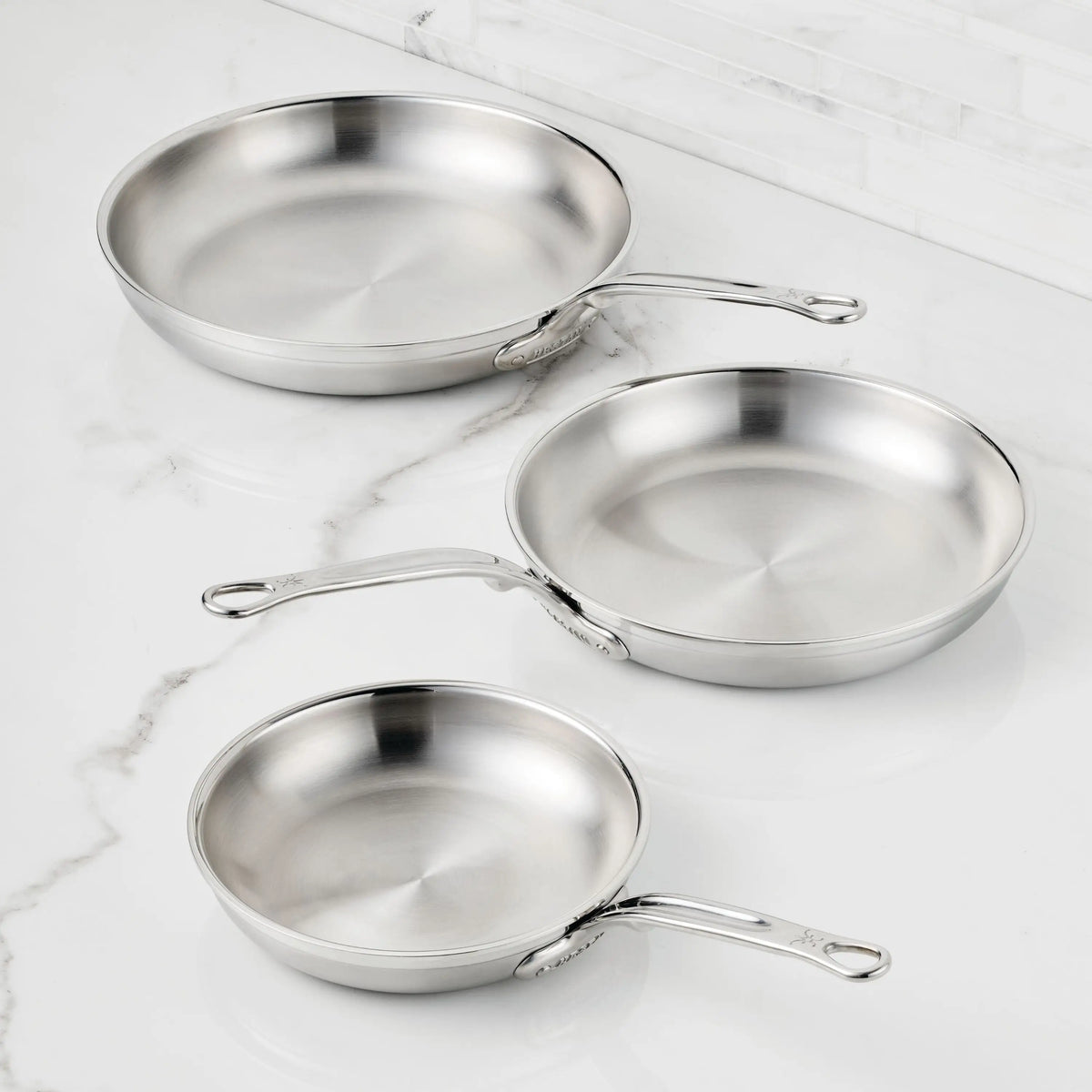 IMG: Brushed Clad Stainless Steel Skillets on marble countertop