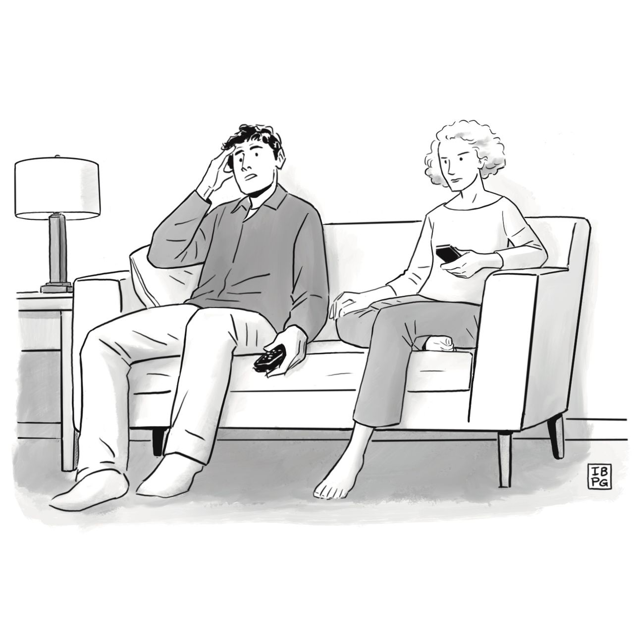 A stressed-looking man and woman sit on a couch, watching television.