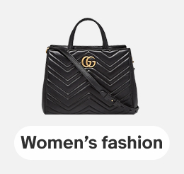  A Gucci GG Marmont matelassé top handle bag in black leather on a gray tile.