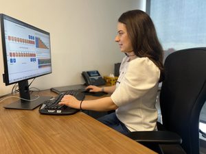 a woman sits at a computer