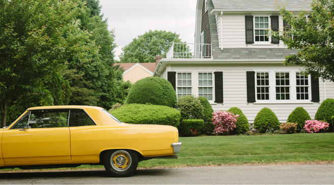 Classic car outside of a colonial style home