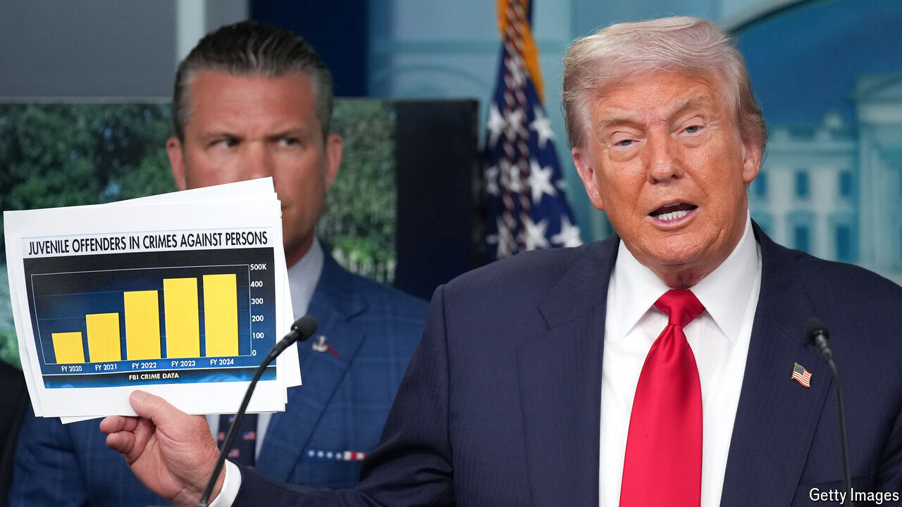 President Donald Trump shows crime statistics as he delivers remarks during a press conference.