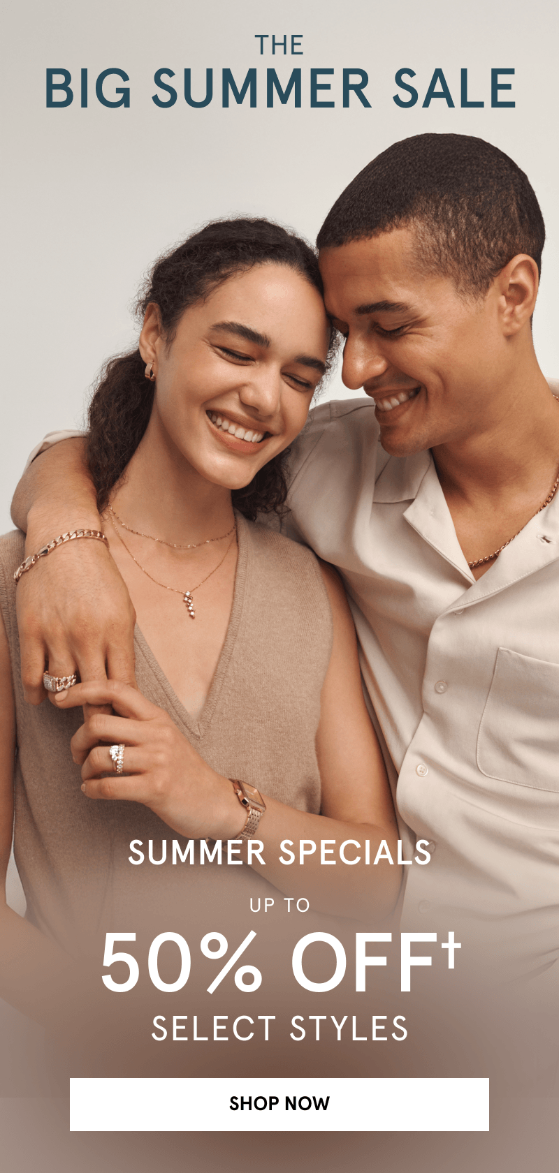 Couple wearing yellow gold necklaces, rings, and bracelets. The big summer sale. Up to 50% Off select styles. Click shop now.