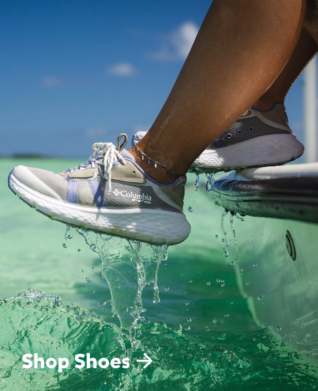A close of up someone pulling their PFG shoes out of the water while on a boat.