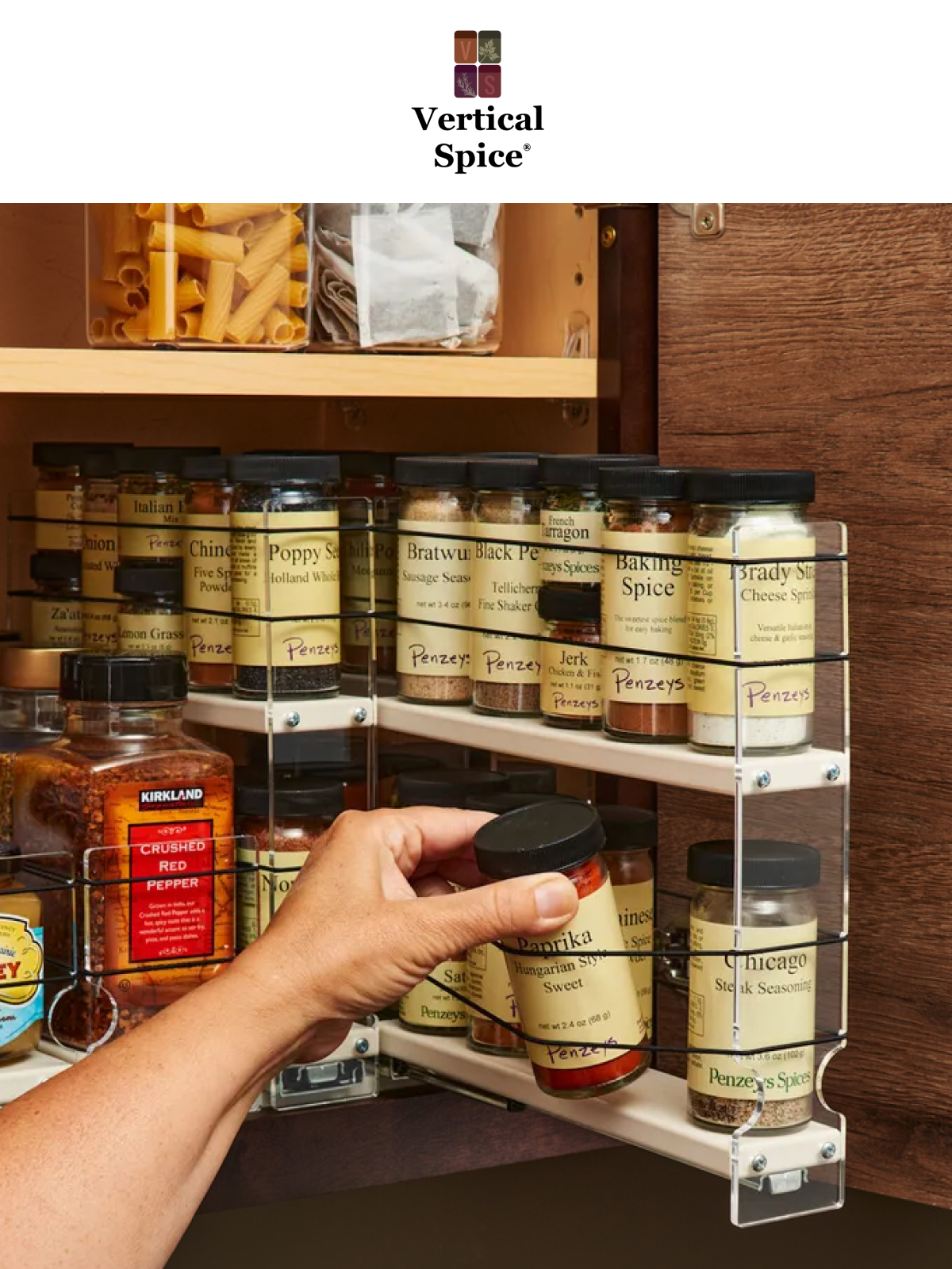 Pull-out spice rack drawer installed in a deep kitchen cabinet, showing organized spice jars on sliding shelves for easy access