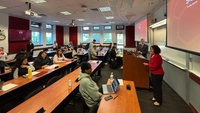 speaker presents to class in front of classroom