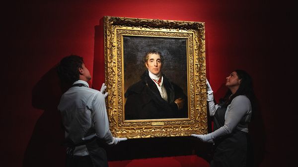Christie's staff pose with a painting of the Duke of Wellington by Sir Thomas Lawrence