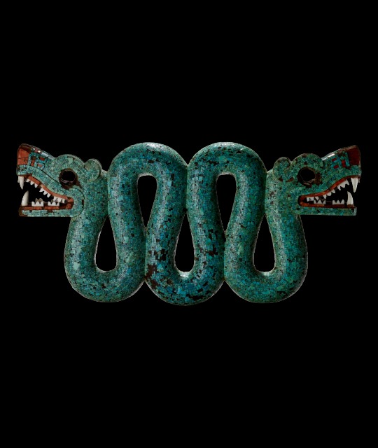 An Aztec sculpture of a snake with two heads composed of mostly turquoise pieces applied to a wooden base. 