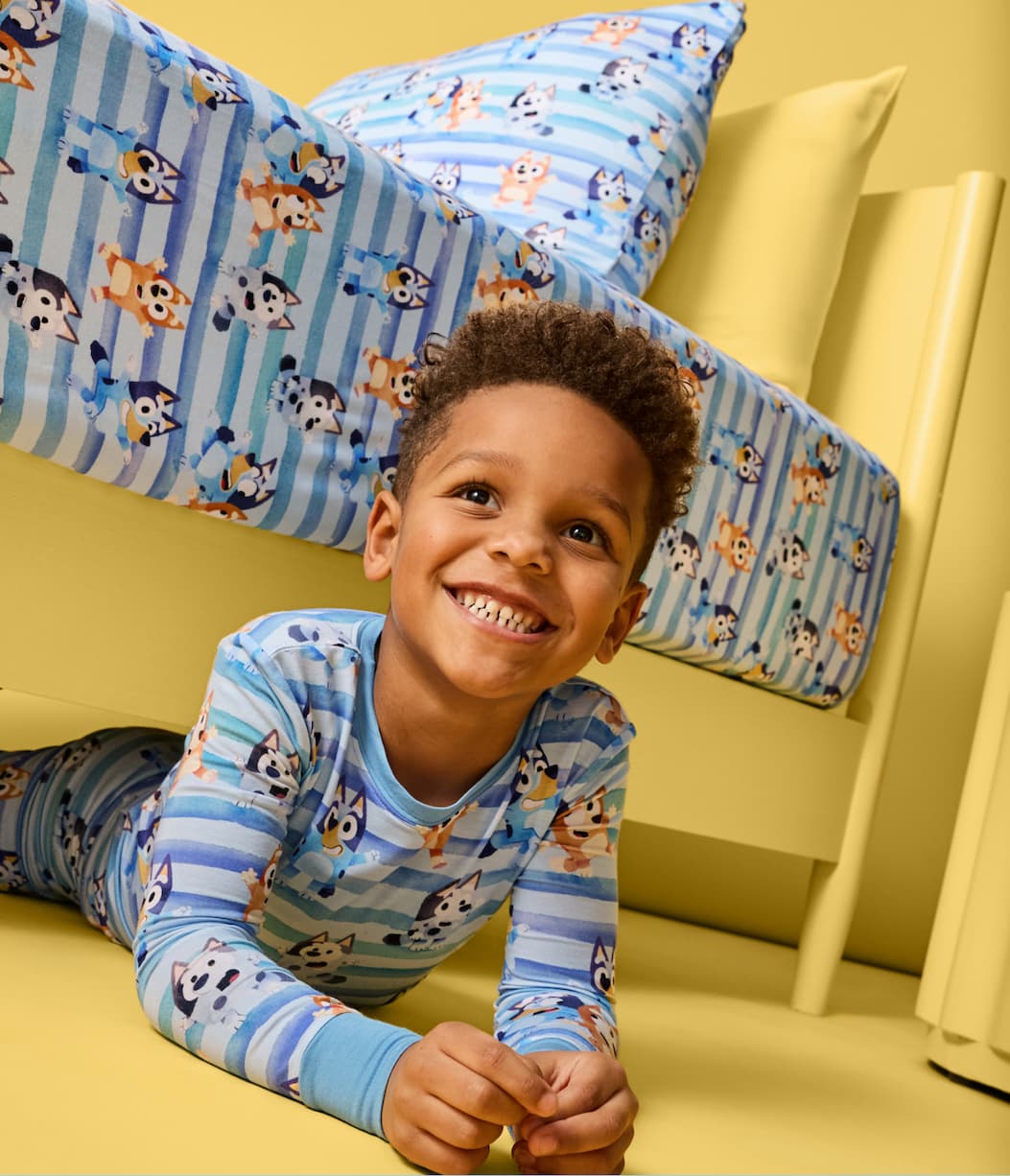 Bluey Collection | Smiling child in bedroom wearing Bluey PJs