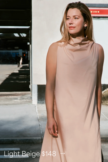 Nane in the Minna Sleeveless Dress stands under sunlight, with text showing “Light Beige $148.”