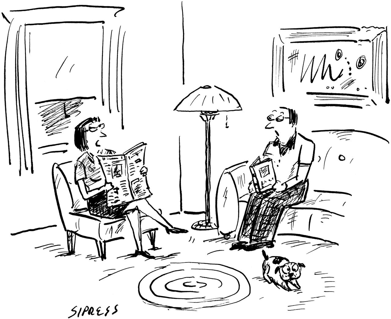 Two people sit in their living room.