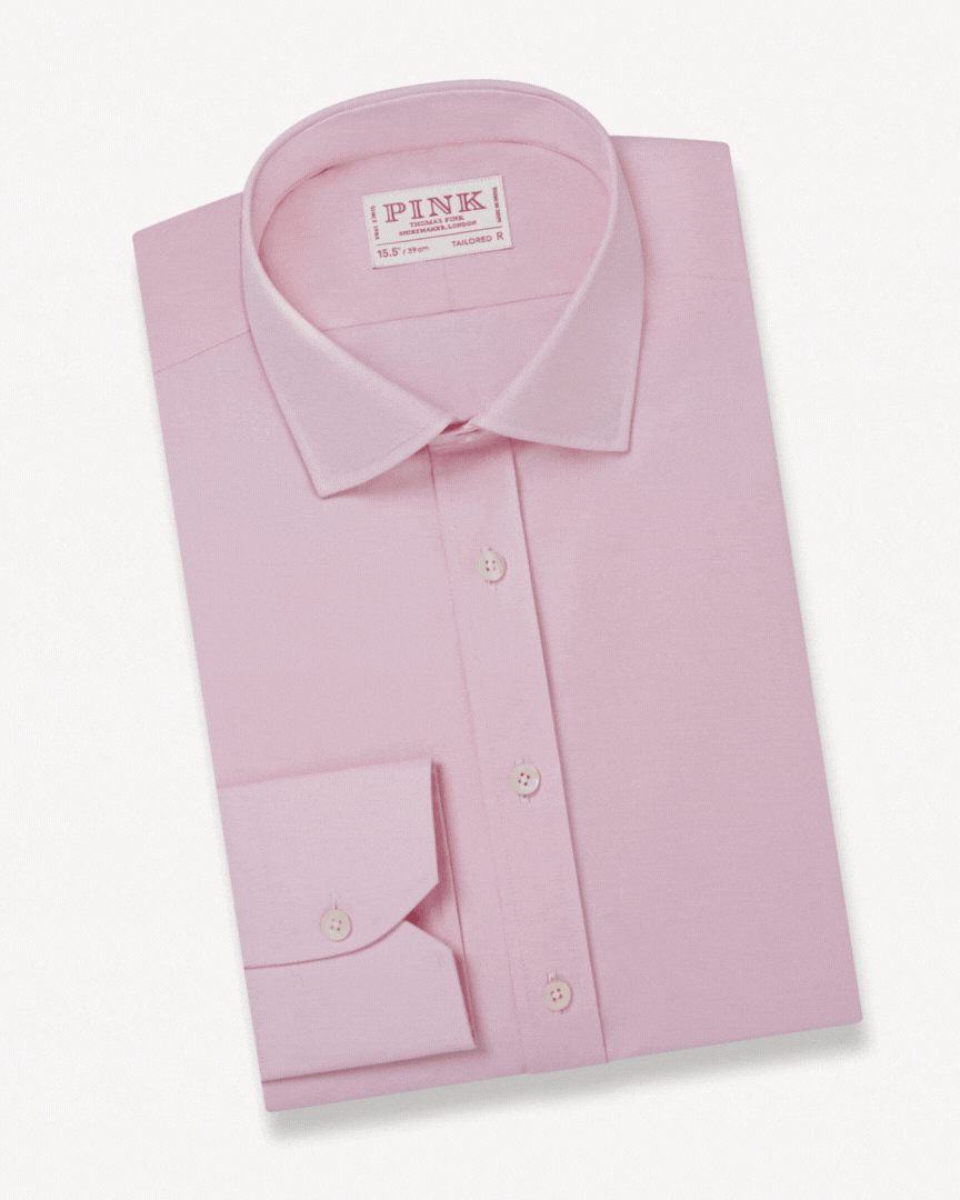 an image of a stack of three shirts with a white shirt on top