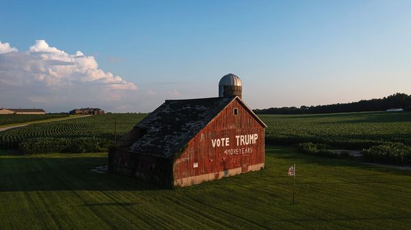 Aerial view of a barn on a farm that says 'Vote Trump' written on it.