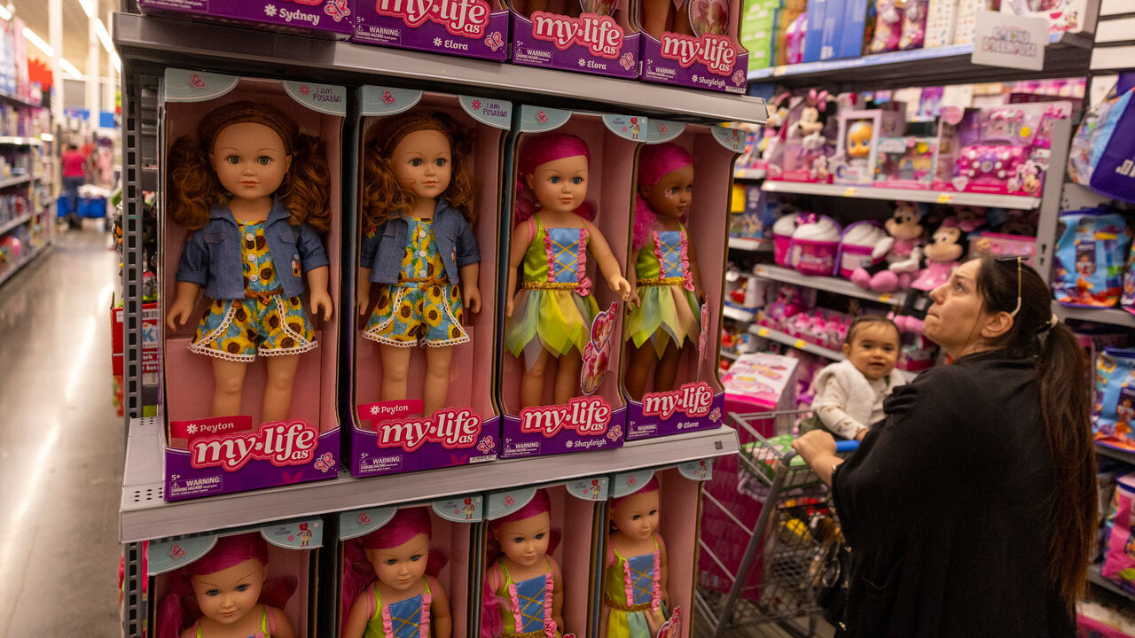 A woman and toddler look over dolls on the shelves at a Walmart Supercenter in Burbank, California, USA.