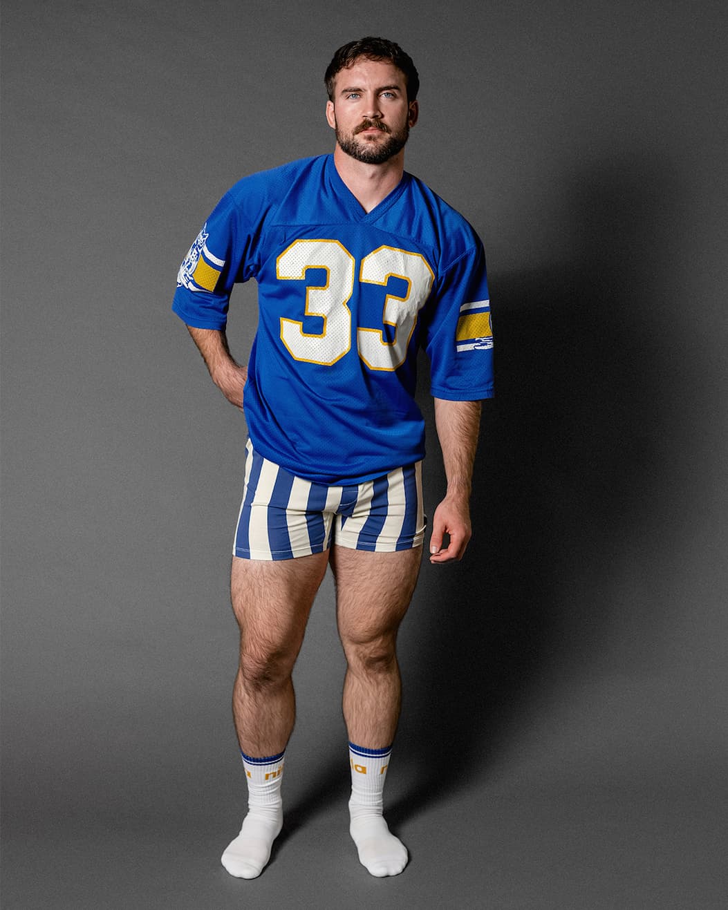 Man in studio wearing blue jersey and blue/white striped cabana slim fit boxers