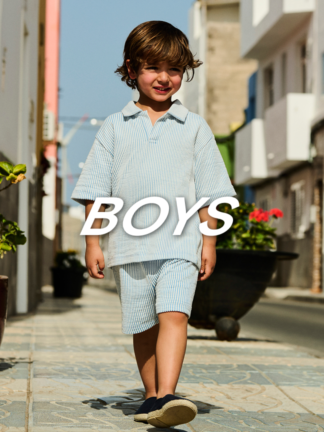 Boys. Young boy wearing a pale blue co-ord