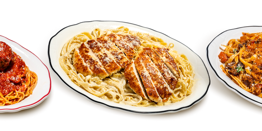 Three plates of Maggiano’s entrées including Spaghetti and Meatballs, Chicken Fettuccine Alfredo, and Fettuccine Bolognese