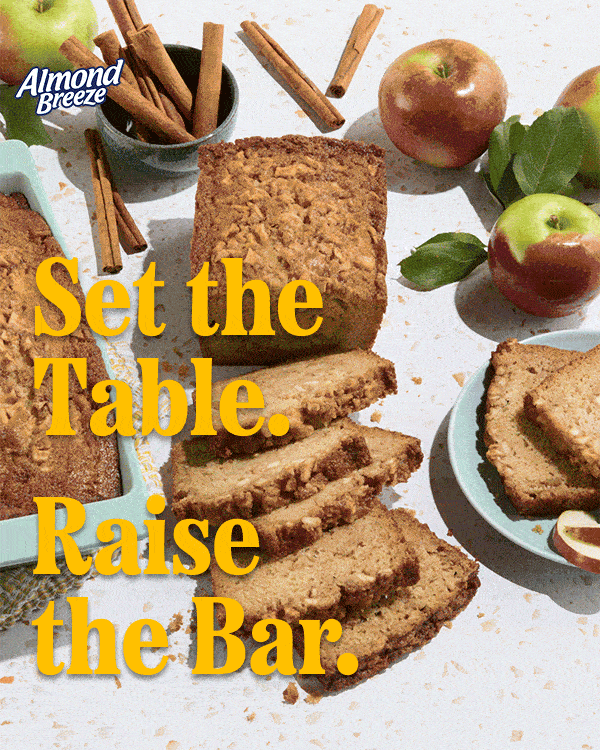 GIF of cinnamon apple bread made with Almond Breeze. A loaf is sliced on a table surrounded by apples and cinnamon sticks. Yellow text reads: ‘Set the table. Raise the bar.’ Almond Breeze logo in corner.