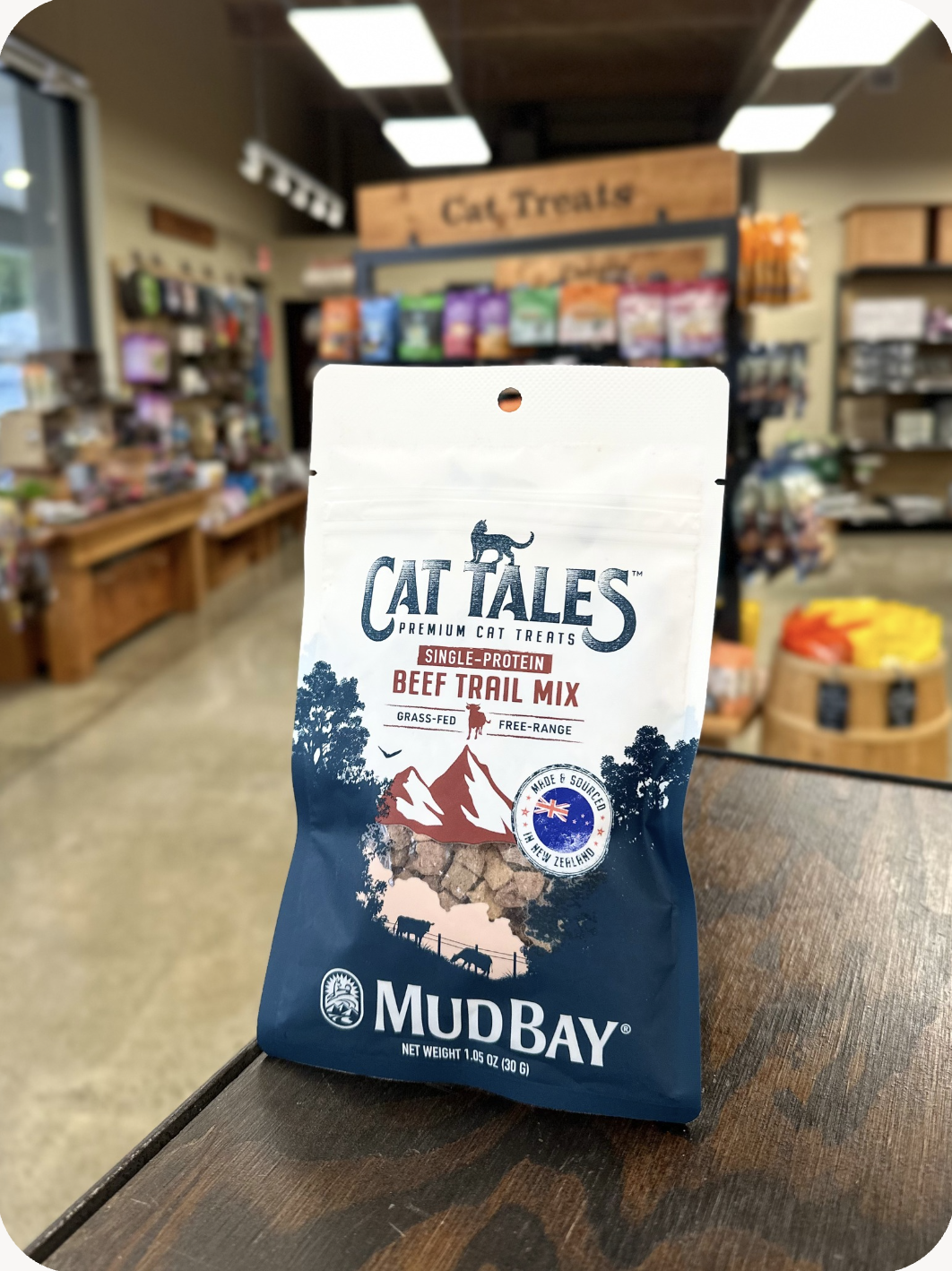 A photo of a 1oz bag of Mud Bay Cat Tales Freeze-Dried Beef Trail Mix Cat treats sitting on the counter.