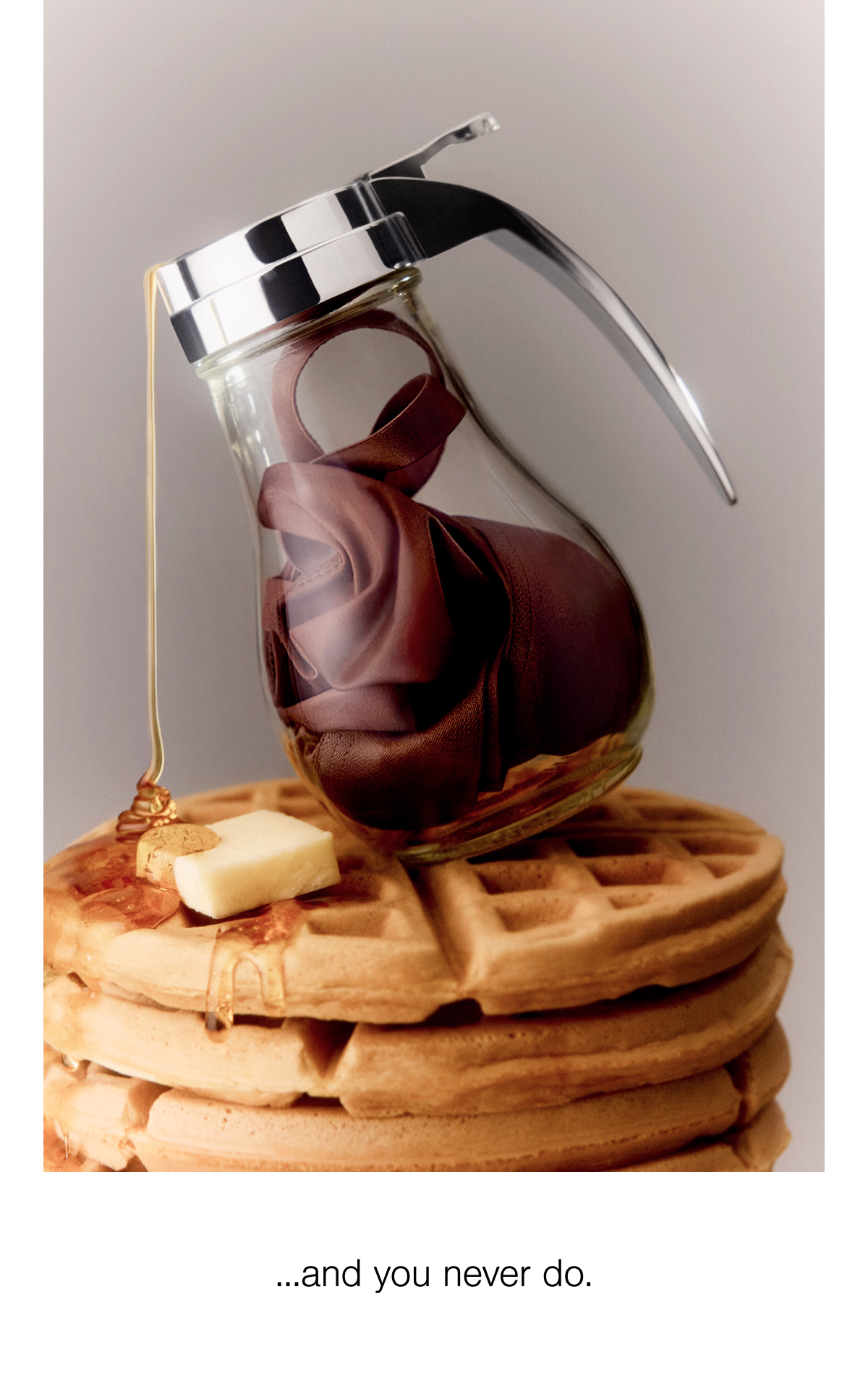 An image of Syrup pouring over a stack of Waffles. 