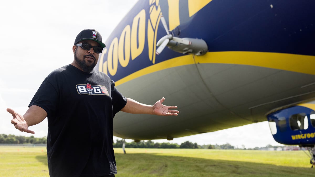 Ice Cube standing in front of the Goodyear Blimp