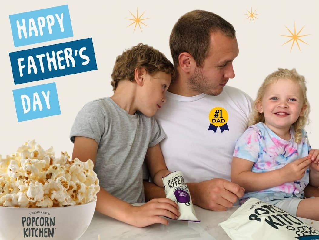 2 children and dad and popcorn