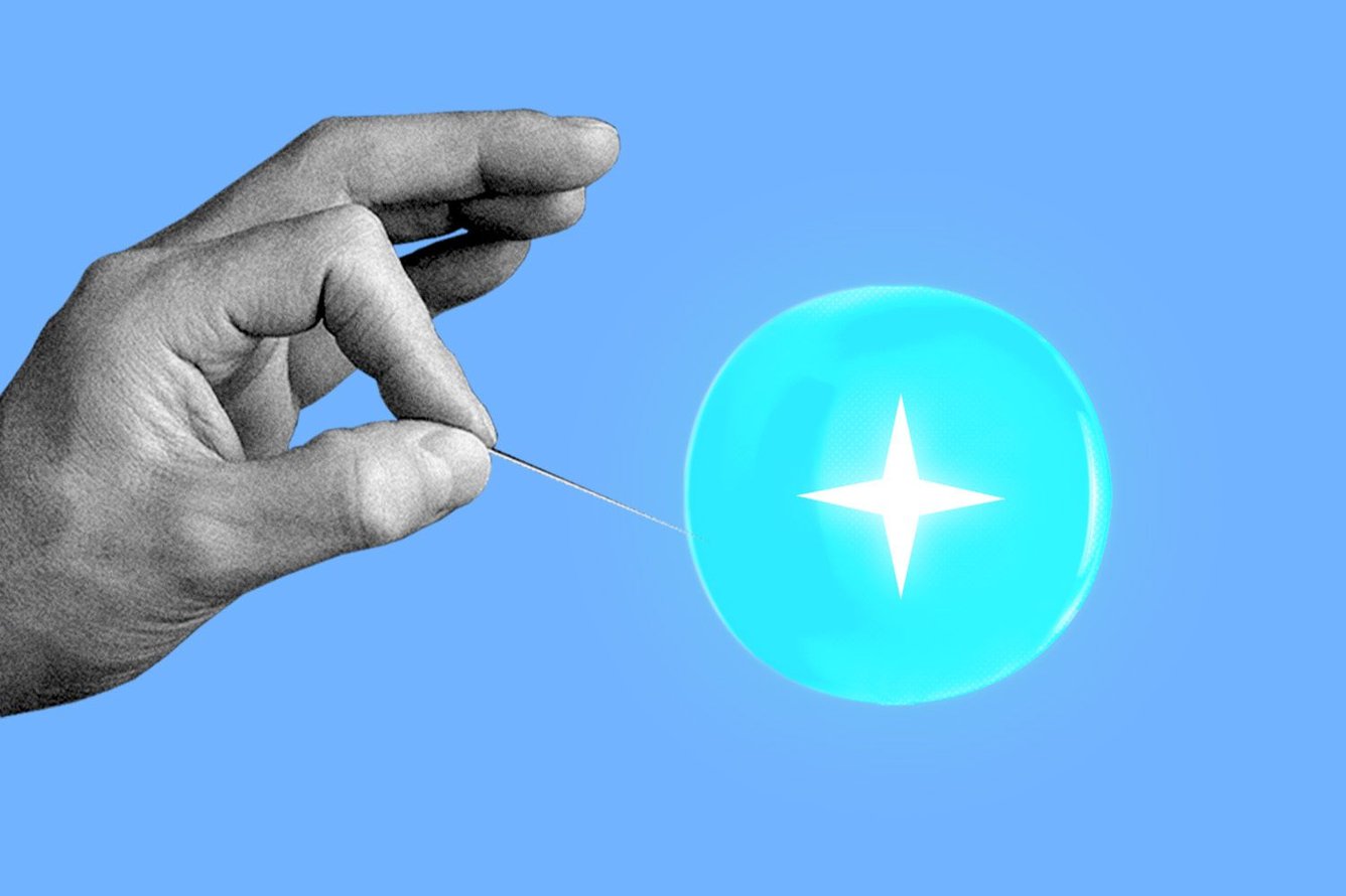 A hand holding a pin to pop a bubble