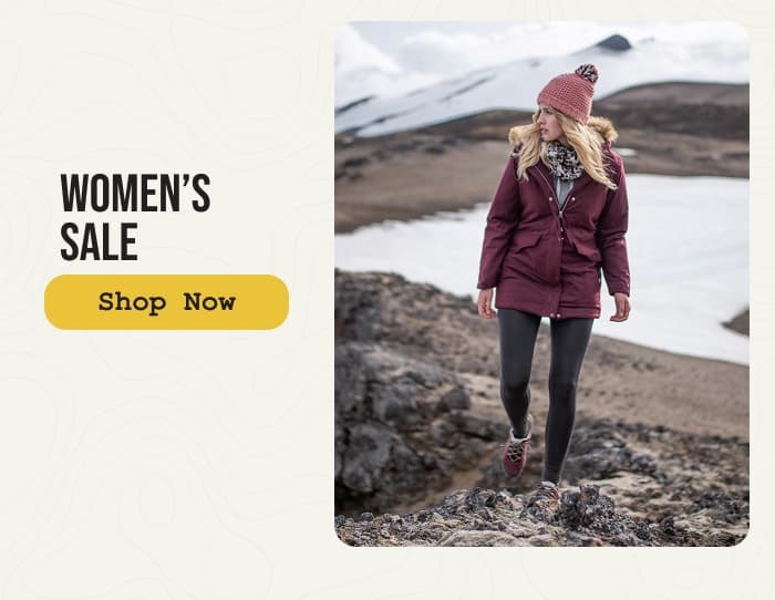 Photo of a woman hiking around a snowy volcano while wearing Craghoppers jackets. Women's sale. Shop Now.
