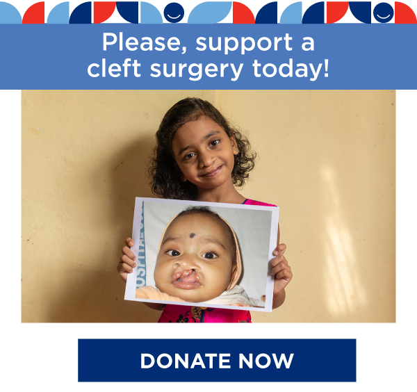 Child holding a baby photo of herself before a successful cleft surgery