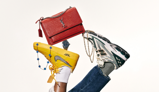 A yellow Nike sneaker and a green and white New Balance sneaker hold up a red Louis Vuitton bag, two necklaces, and a watch.