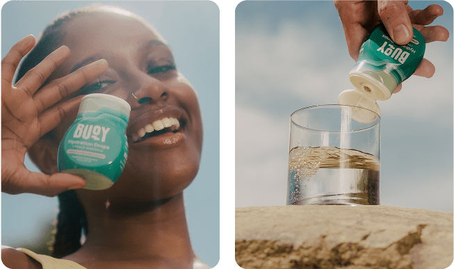 Smiling woman holding Buoy Hydration Drops and drops being added to a glass of water outdoors.