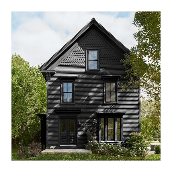 A large house with black painted siding, trim, and doors.