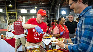 Mike Kotlikoff serving food