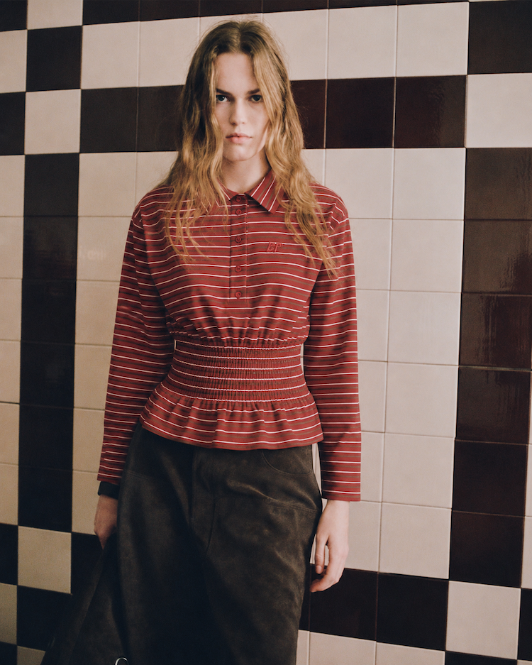 Model in red striped shirt and brown suede jeans