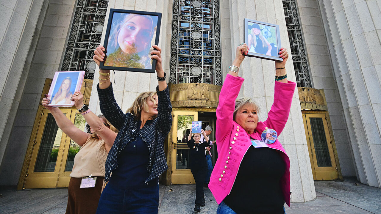 Relatives of young female victims of social media hold up their portraits outside Los Angeles Superior Court