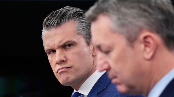 Defense Secretary Pete Hegseth looks toward Chairman of the Joint Chiefs of Staff Gen. Dan Caine.