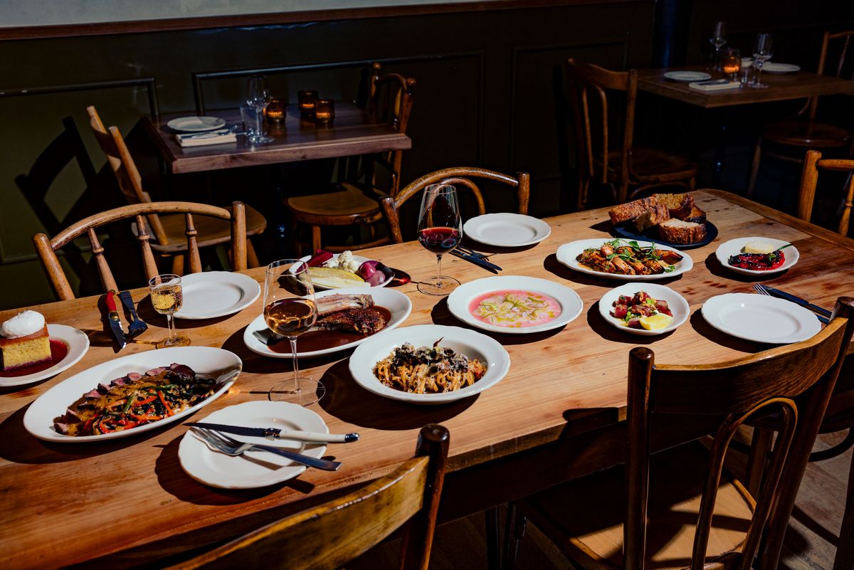 A wooden table full of various dishes.