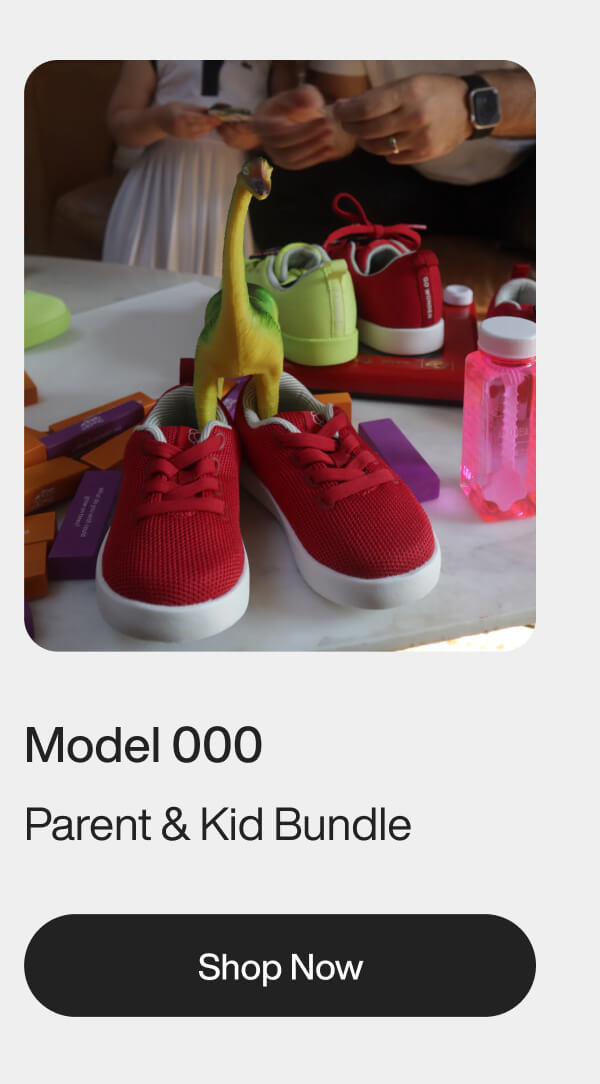 Red and green shoes on white table with toy dinosaur; people in background. Text: Model 000, Parent & Kid Bundle, Shop Now.