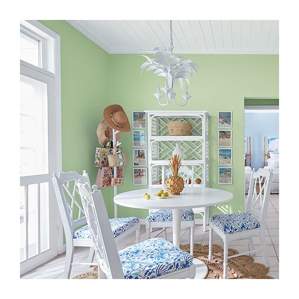A light green kitchen with white painted ceiling and trim.