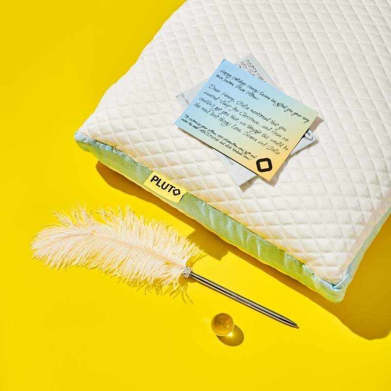 a white feather pen and a white pillow