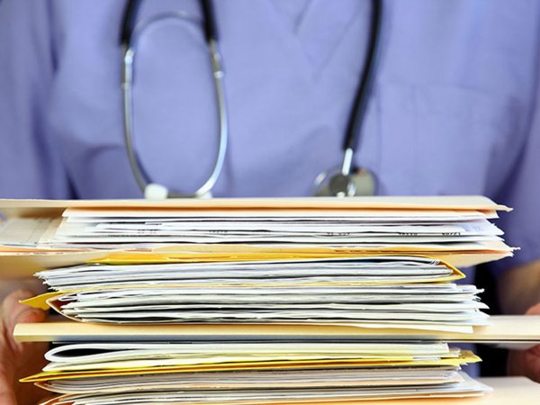 Doctor holding files.