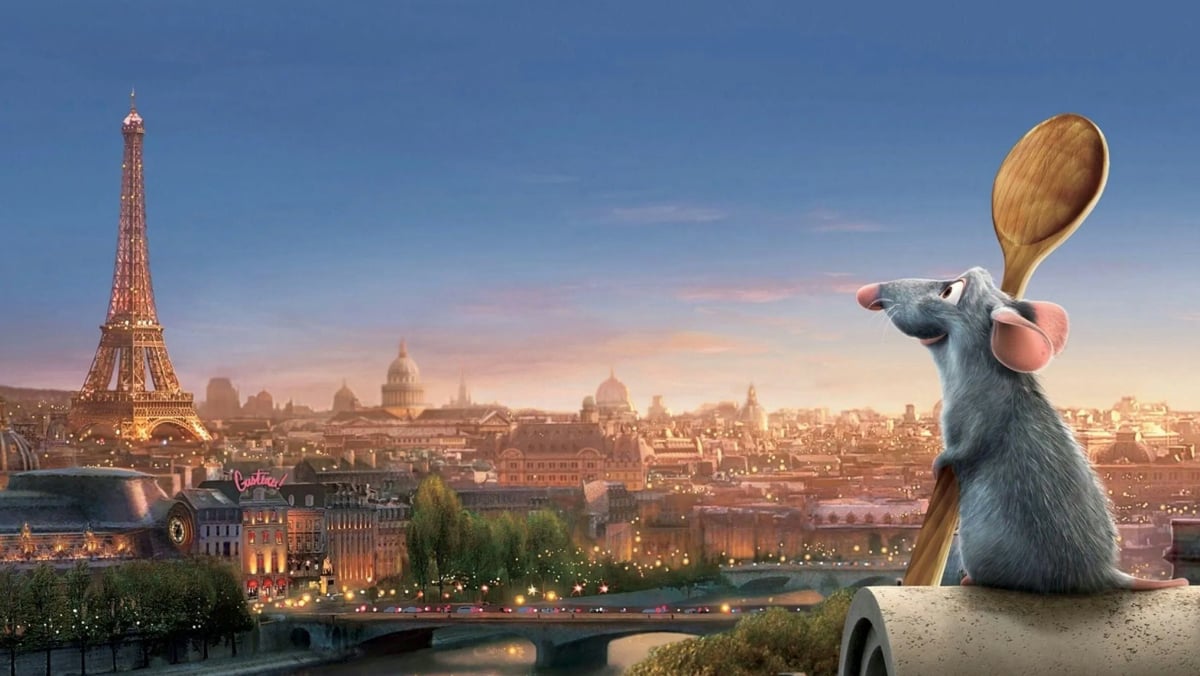 This is an image from the animated 2007 movie Ratatouille. It features the rat Remy holding a wooden spoon and looking out onto the Paris landscape, with the Eiffel Tower in the left corner.