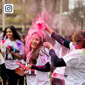 Penn students dump colorful powder on each other to celebrate Holiday.