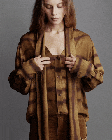 b'The model is wearing The Silk Oversized Tie Shirt in Light Tiger Multi paired with The Reboot Corduroy in Bronze'