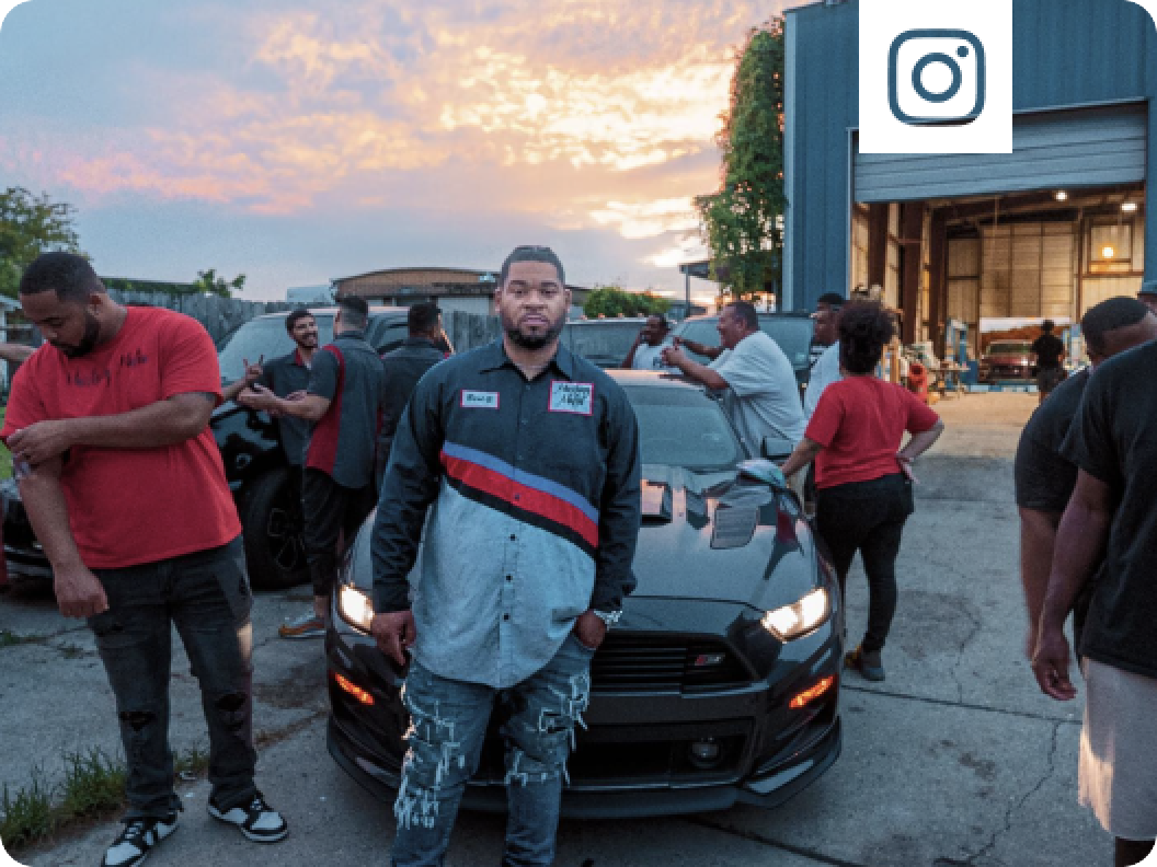 A group of people standing around a Ford Mustang&reg; coupe